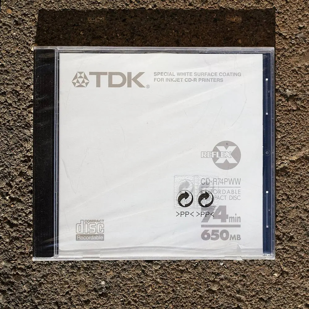 A CD case sealed in tight, clear shrink film.