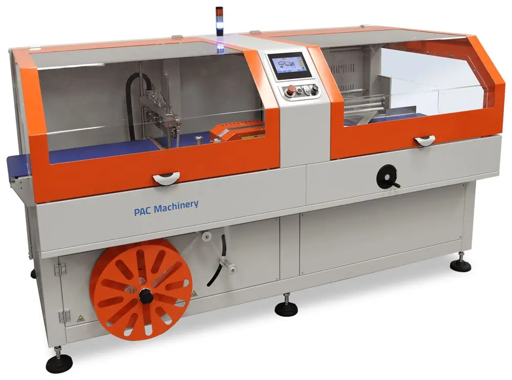 An orange and gray Clamco continuous motion side sealer with guarded seal area and film unwind below.