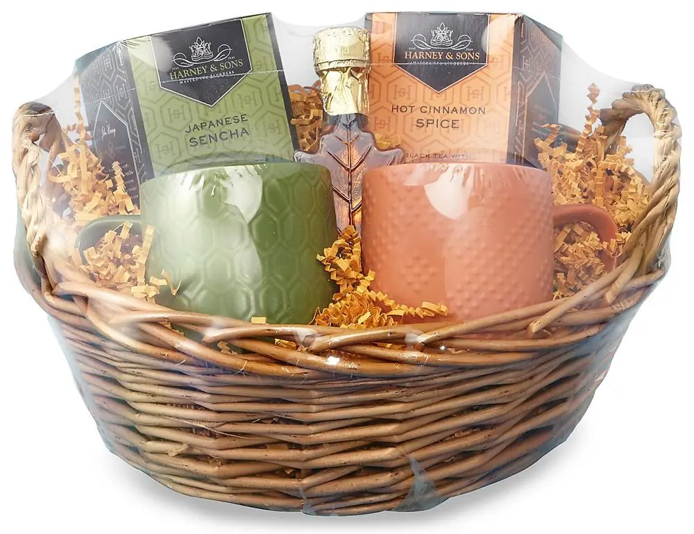 A gift basket with tea and mugs sealed in a clear dome shrink bag.
