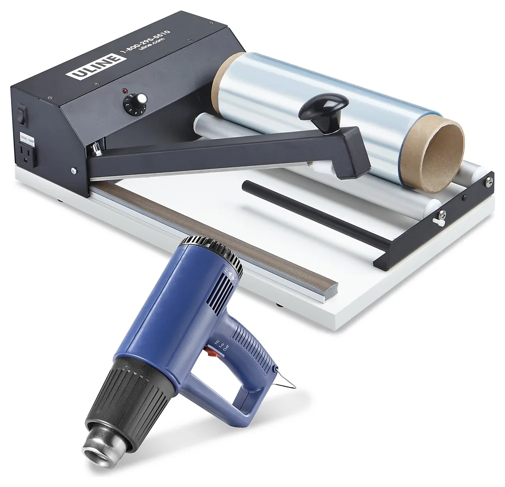 A black and white tabletop I-bar sealer with one straight seal arm, a roll of clear film on rollers behind it, and a blue heat gun in front.